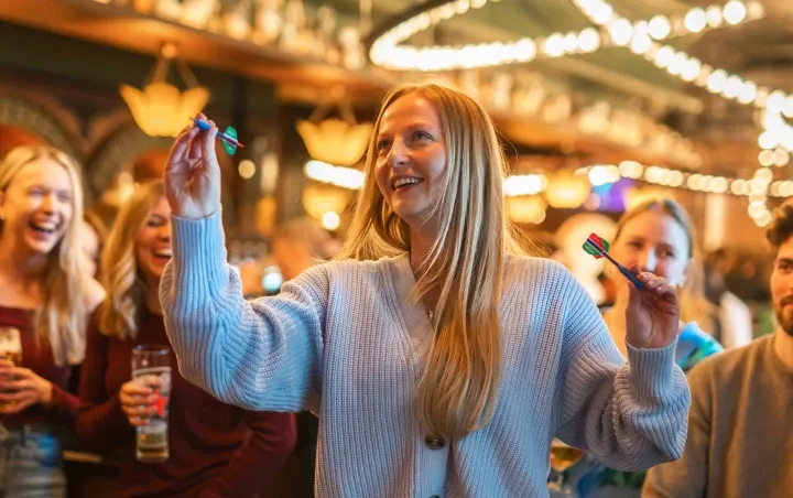 A group of students playing darts at Flight Club
