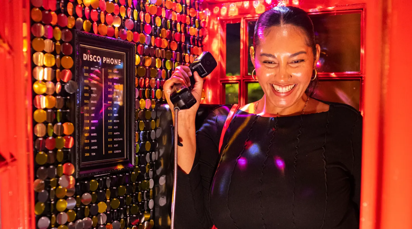 A person in a disco phonebooth