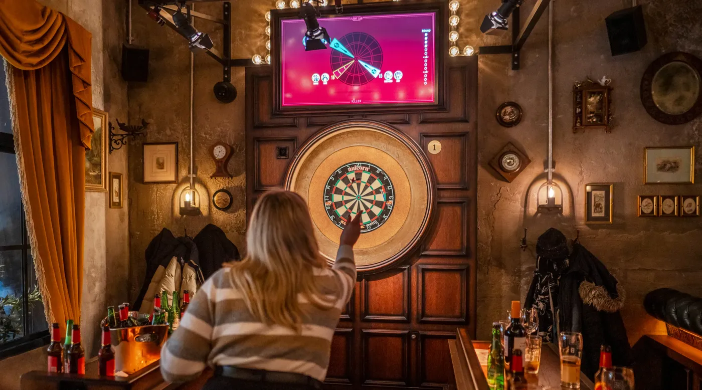 A person throwing a dart at Flight Club