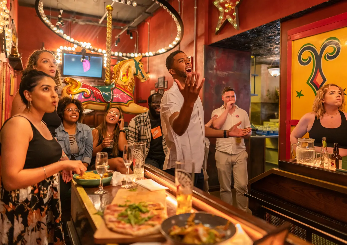 A group of people playing darts at a team event in Flight Club